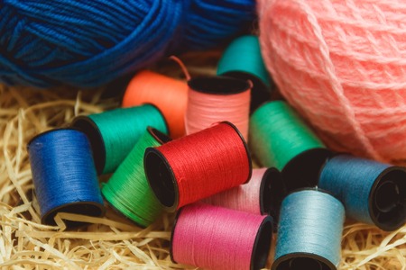 Hanks of bright yarn for knitting on a bright background with copyspace
