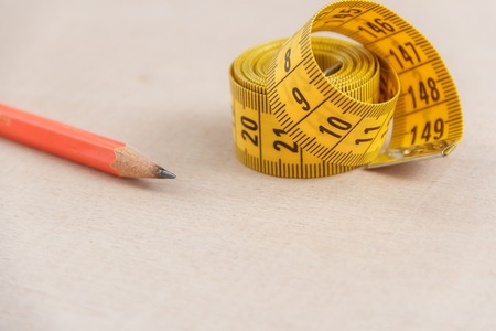 Curved measuring tape with copyspace. Closeup view of yellow measuring tape.の写真素材