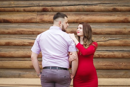 Happy young couple expecting baby in summer parkの写真素材