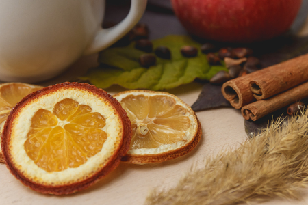 Cocoa or latte or hot chocolate with cinnamon, apple and dried orange. On a bright wooden background. Christmas present. Christmas concept. Christmas holiday.の写真素材