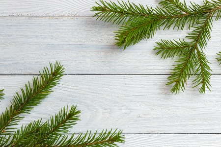 new year and christmas mockup - fir branch on white wooden background.の写真素材