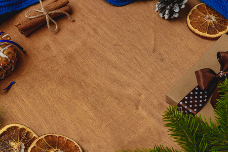 Christmas background with fir, scarf, dry orange, cone, biscuits, cinnamonの写真素材