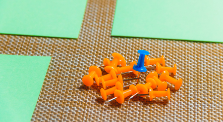 Stationary, Orange, Blue Pushpins Heap on Brown Background, Concept for Difference, Individuality.