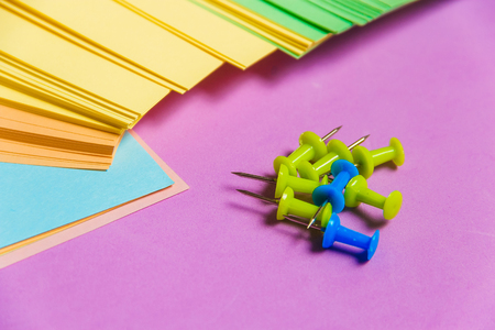 Stationary, Pushpins Heap, Blank Colored Sticker on Lilac Board. Time-management, Planning.の写真素材