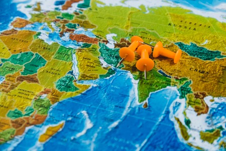 Travel Destination Points on World Map Indicated with Colorful Thumbtacks and Shallow Depth of Field.の写真素材