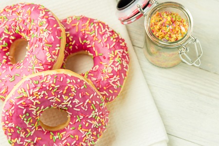 Donut on a kitchen towel and on a wooden table. Photo of sweets.の写真素材