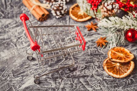 Shopping cart with gift or present on concrete table. Christmas and New year sale conceptの写真素材
