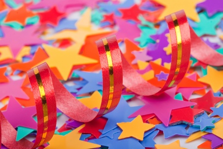 Streamer on the background of multicolored confetti starsの写真素材