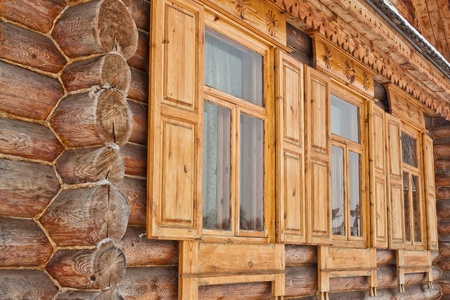Three carved windows of old wooden houseの写真素材