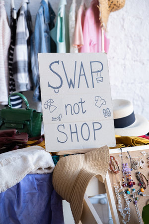Swap not shop invitation poster with stylized lettering and style decoration. Event for exchange of clothes, shoes and accessories. Reduce and reuse concept. Idea of exchange your old wardrobe for newの写真素材