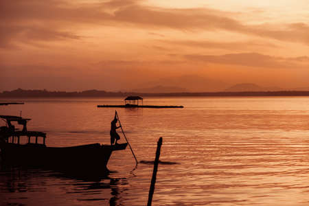 Amazing colorful sunrise at tropical islands. Beautiful cloudscape over the sea. Silhouettes in...