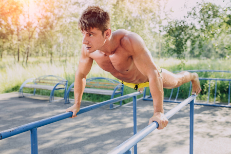 Attractive guy working out outdoors on a sunny summer dayの写真素材