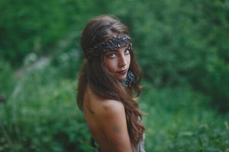 Beautiful woman in bodyart on the summer forest backgroundの写真素材