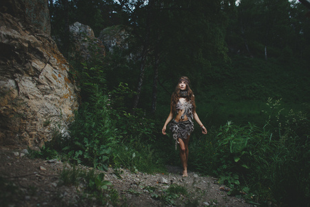 Beautiful woman in bodyart on the summer forest backgroundの写真素材