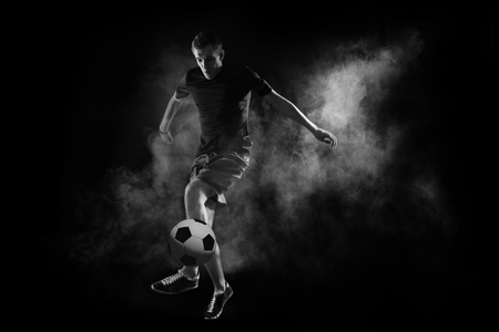 bright soccer player on the black backgroundの写真素材