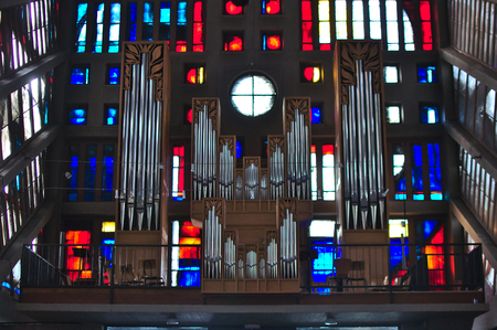 organs on a balcony inside a church colored windows in the backのeditorial素材