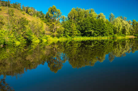 Sunny day on the quiet river in summer in Ukraineの写真素材