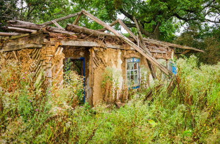 Ruins of an old abandoned house in the summerの写真素材