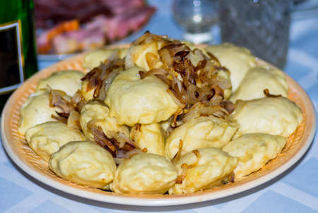 Ukrainian national dish dumplings of unleavened dough cooked with various fillings: cheese, potato, onion, cabbage, mushrooms, fruit apple, cherryの写真素材