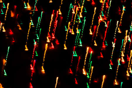 Colorful beautiful multi-colored Christmas lights on a black backgroundの写真素材