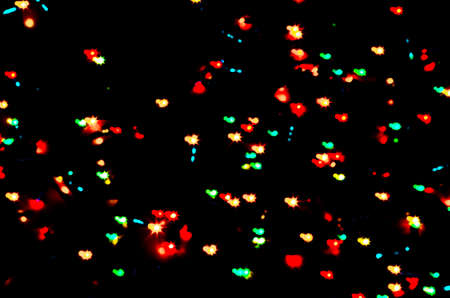 Colorful beautiful multi-colored Christmas lights on a black background