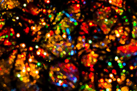 Colorful beautiful multi-colored Christmas lights on a black backgroundの写真素材