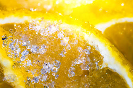 Sugar on a beautiful sliced lemon slice close backgroundの写真素材