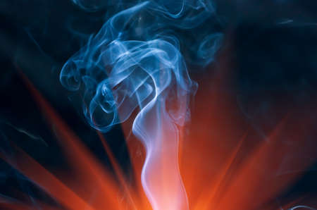 Beautiful cigarette smoke on a dark backgroundの写真素材
