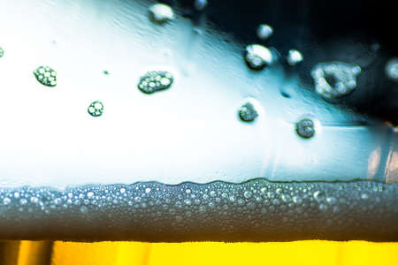 bubbles on a light beer in a plastic bottleの写真素材