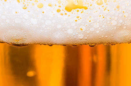 Light beer poured in a glass closeupの写真素材