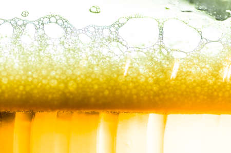 Light beer poured in a glass closeupの写真素材