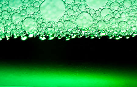 Abstract background of green bubbles of detergent closeの写真素材