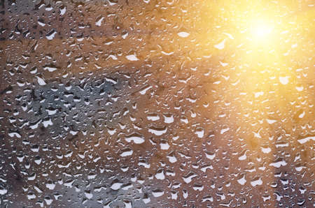 dark background Rain drops on glass closeの写真素材