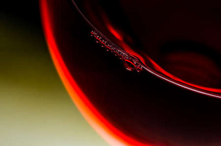 Bubbles in a glass of red wine closeの写真素材