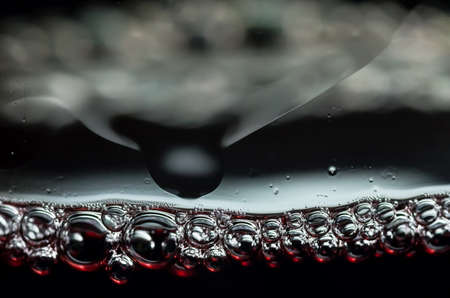 Bubbles in a glass of red wine closeの写真素材