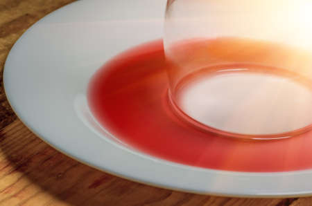 unfinished spilled wine on a white dishの写真素材