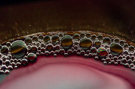 Bubbles in a glass of red wine closeの写真素材