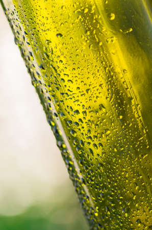 Drops of water on a glass green bottleの写真素材