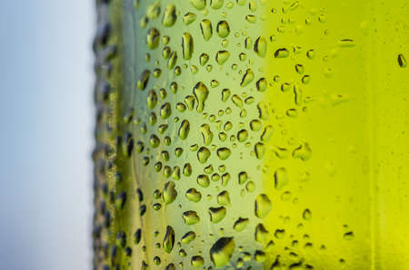 Drops of water on a glass green bottleの写真素材