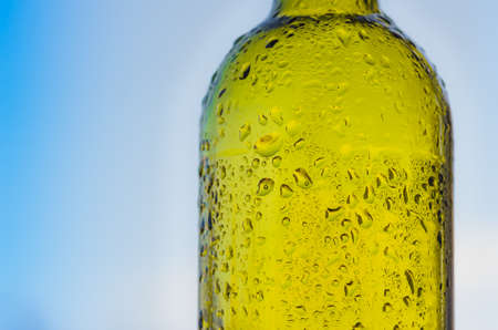 Drops of water on a glass green bottleの写真素材