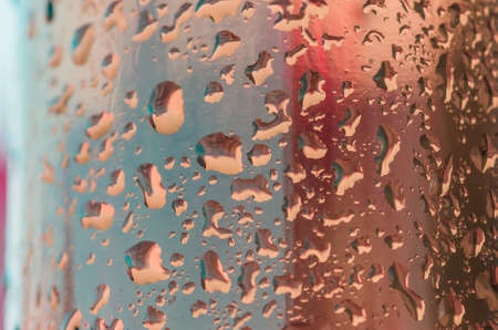 water droplets on a glass bottle during sunsetの写真素材