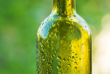 Drops of water on a glass green bottleの写真素材