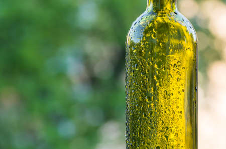 Drops of water on a glass green bottleの写真素材