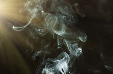 white cigarette smoke on a black backgroundの写真素材