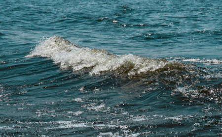 The waves and splashes in the water in windy weather, natural backgroundの写真素材