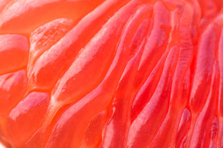 cleaned, juicy red inside grapefruit, closeup backgroundの写真素材