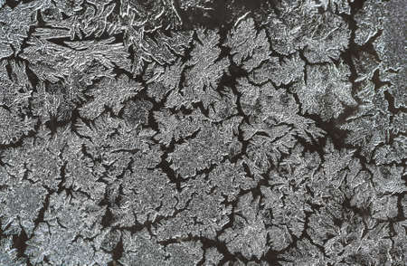 Ice patterns on glass on Christmas Eve. winter backgroundの写真素材