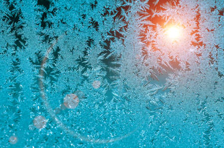 Ice patterns on glass on Christmas Eve. winter backgroundの写真素材