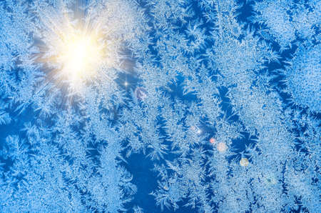 Ice patterns on glass on Christmas Eve. winter backgroundの写真素材
