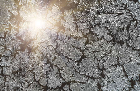 Ice patterns on glass on Christmas Eve. winter backgroundの写真素材